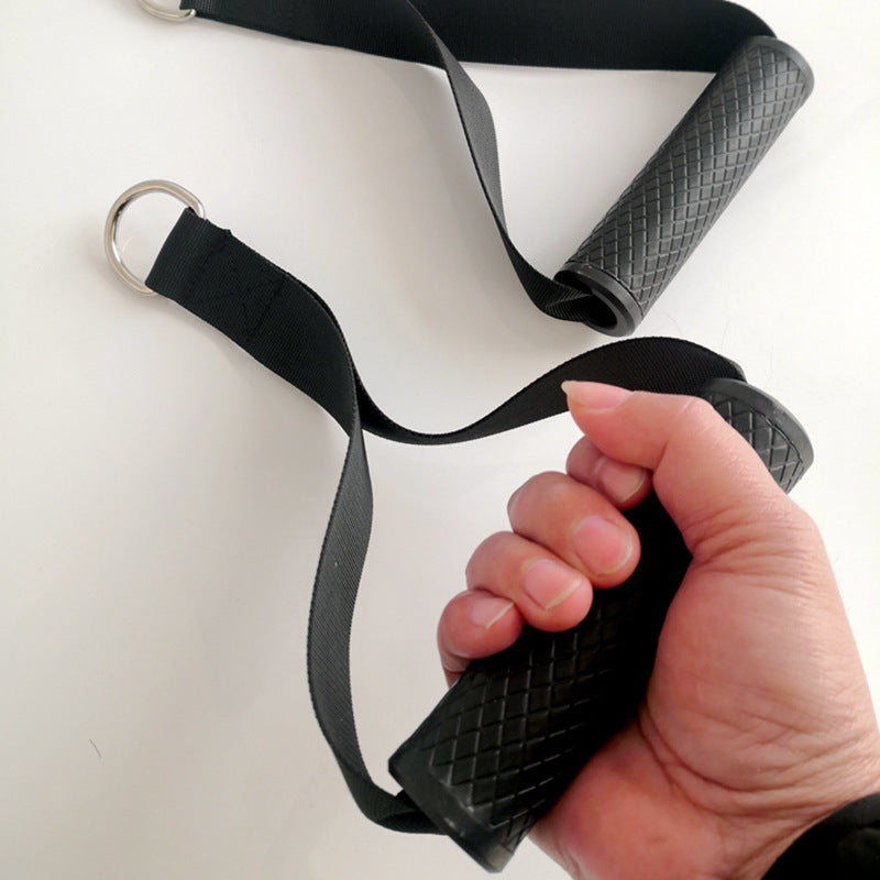 Black resistance band with textured handles held by a hand on a white background